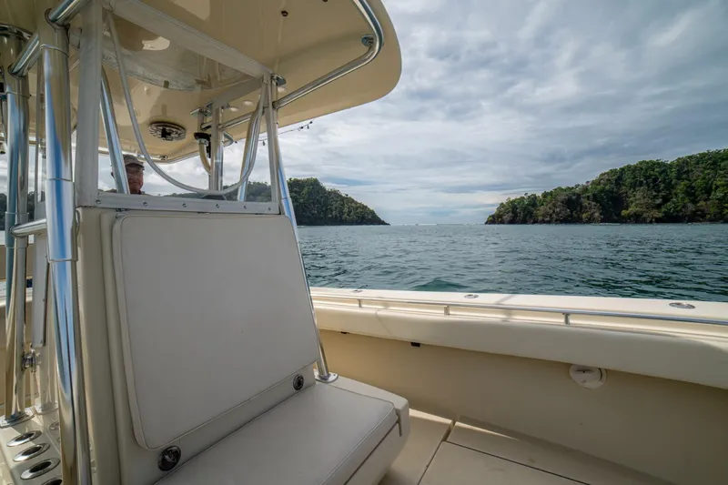 D Flawless Yacht Photos Pics 2007 Contender 33 boat on calm sea with lush islands in the background.