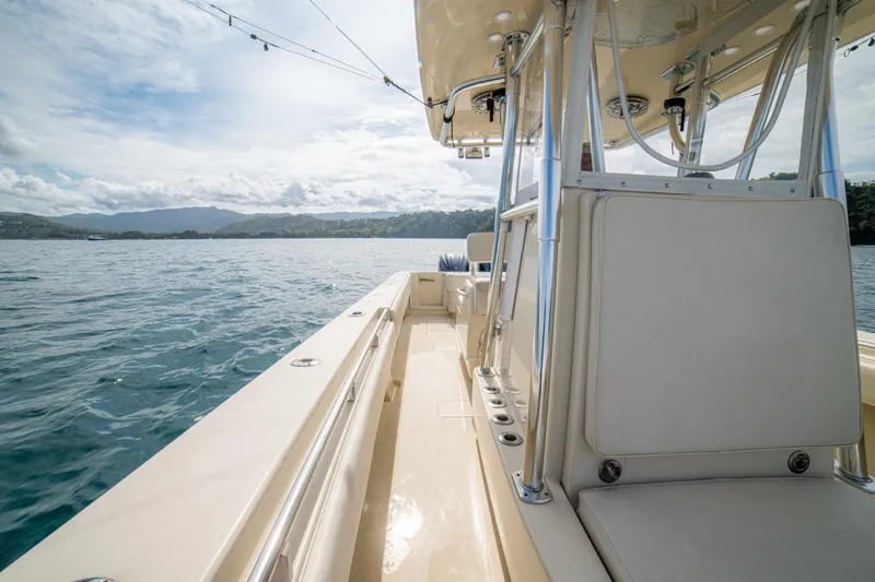 D Flawless Yacht Photos Pics 2007 Contender 33 boat on calm waters with scenic mountain backdrop.