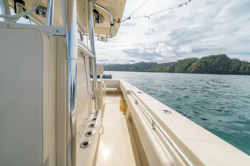 D Flawless Yacht Photos Pics 2007 Contender 33 boat on calm water, featuring sleek design and spacious deck.