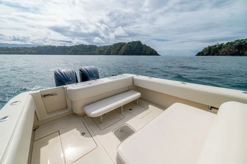 D Flawless Yacht Photos Pics 2007 Contender 33 boat on open water with scenic island view.