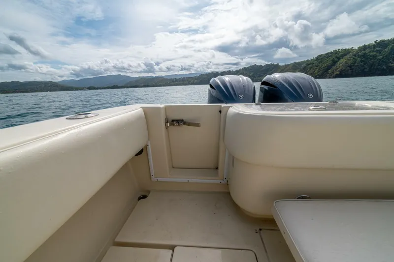 D Flawless Yacht Photos Pics 2007 Contender 33 boat interior with twin engines, scenic ocean view.