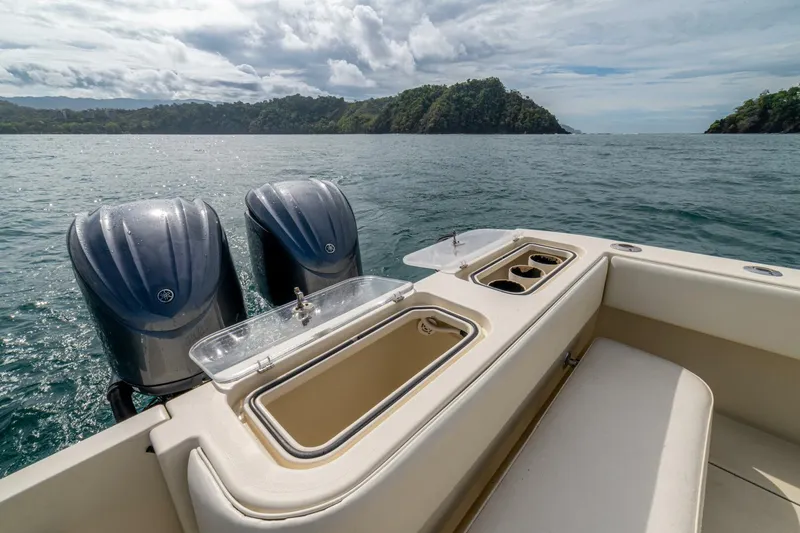 D Flawless Yacht Photos Pics 2007 Contender 33 boat with dual engines, ocean view, and island backdrop.