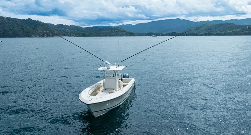 D Flawless Yacht Photos Pics 2007 Contender 33 boat on calm water with mountainous backdrop.