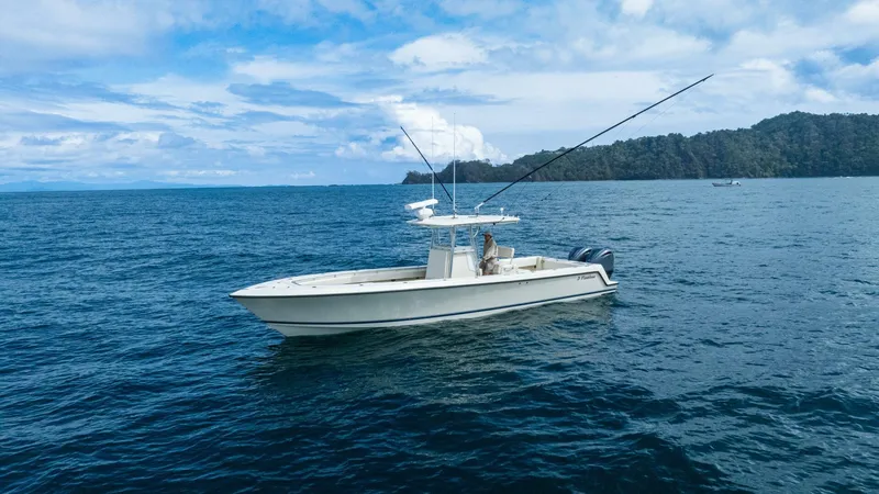 D Flawless Yacht Photos Pics 2007 Contender 33 boat on open sea with scenic coastline background.