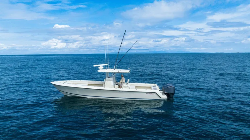 D Flawless Yacht Photos Pics 2007 Contender 33 boat on open ocean under blue sky.