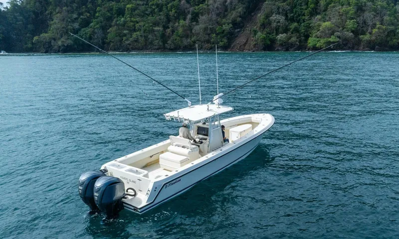 D Flawless Yacht Photos Pics 2007 Contender 33 boat on water, dual engines, lush forested background.