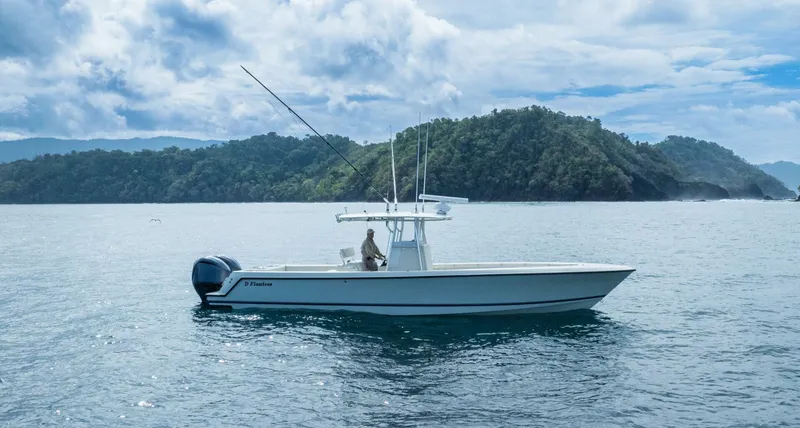 D Flawless Yacht Photos Pics 2007 Contender 33 boat on water with scenic island background.