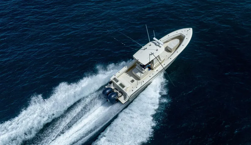 D Flawless Yacht Photos Pics Aerial view of 2007 Contender 33 boat cruising on open water.