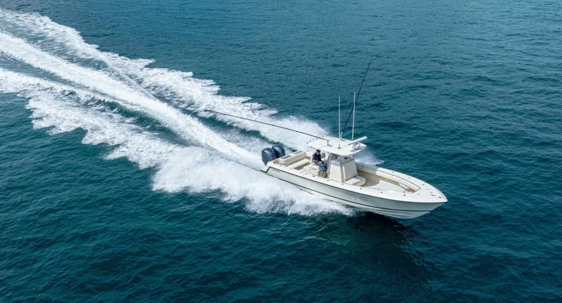 D Flawless Yacht Photos Pics 2007 Contender 33 boat cruising on open water, leaving a wake behind.