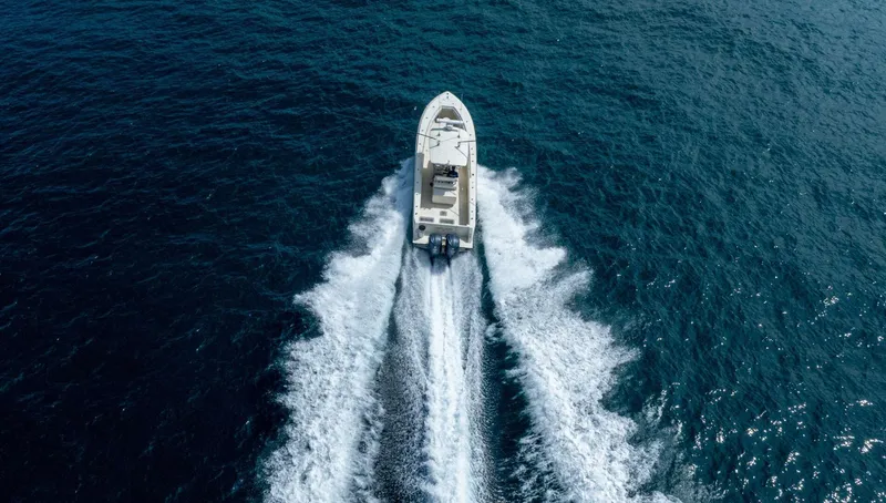 D Flawless Yacht Photos Pics Aerial view of 2007 Contender 33 boat cruising on open ocean waters.