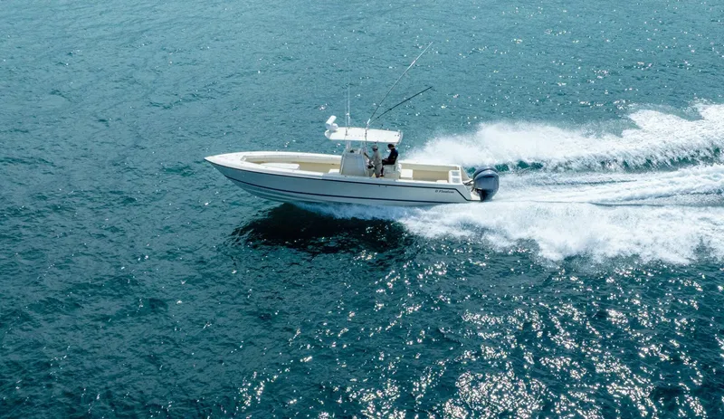 D Flawless Yacht Photos Pics 2007 Contender 33 boat speeding on open water, creating a white wake.