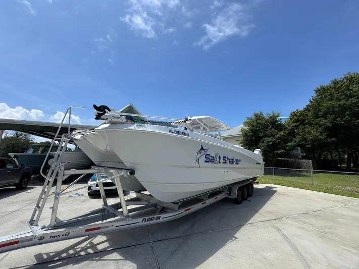  Yacht Photos Pics 2022 Twin Vee 340 GFX CC boat on trailer under clear blue sky.