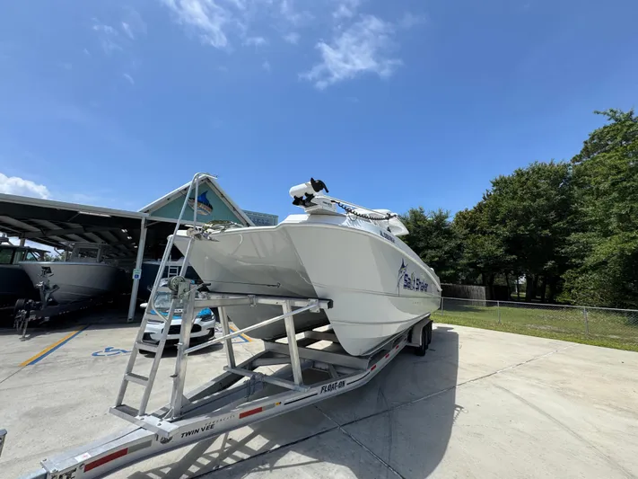  Yacht Photos Pics 2022 Twin Vee 340 GFX CC boat on trailer under clear blue sky.