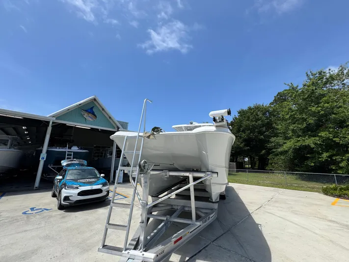  Yacht Photos Pics 2022 Twin Vee 340 GFX CC boat on trailer under clear blue sky.