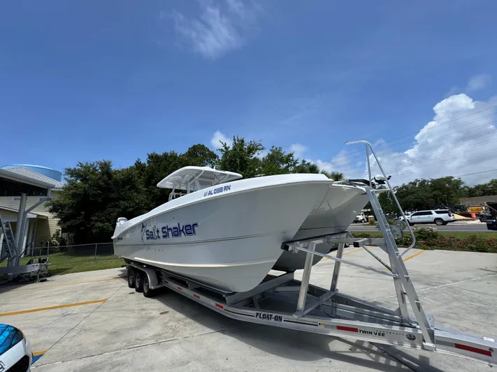  Yacht Photos Pics 2022 Twin Vee 340 GFX CC boat on trailer in parking lot, clear sky background.