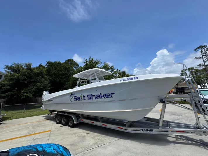  Yacht Photos Pics 2022 Twin Vee 340 GFX CC boat on trailer, labeled "Salt Shaker," parked outdoors.