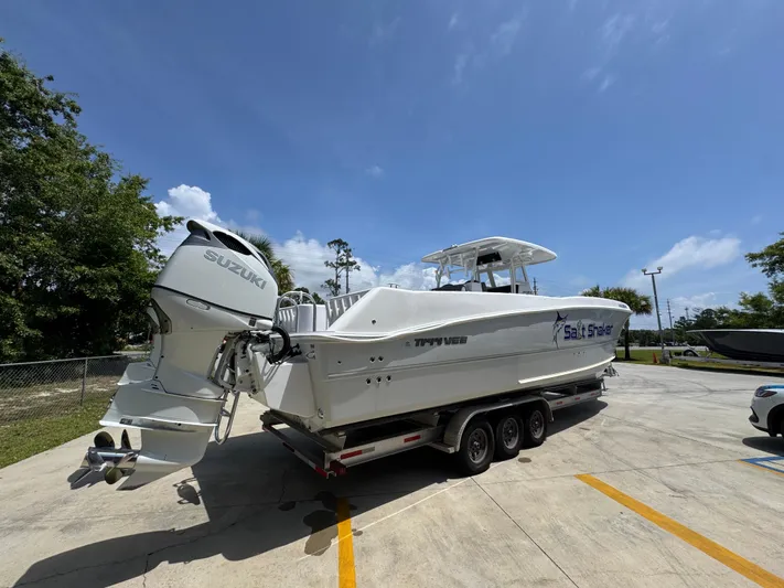  Yacht Photos Pics 2022 Twin Vee 340 GFX CC boat on trailer, parked outdoors under clear sky.