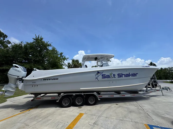  Yacht Photos Pics 2022 Twin Vee 340 GFX CC boat on trailer, labeled "Salt Shaker," under clear blue sky.