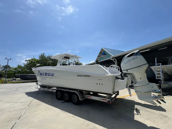  Yacht Photos Pics 2022 Twin Vee 340 GFX CC boat on trailer, parked outdoors under clear sky.