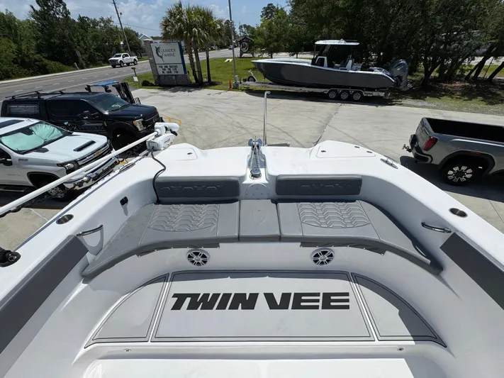  Yacht Photos Pics 2022 Twin Vee 340 GFX CC boat interior with seating and logo, parked outdoors.