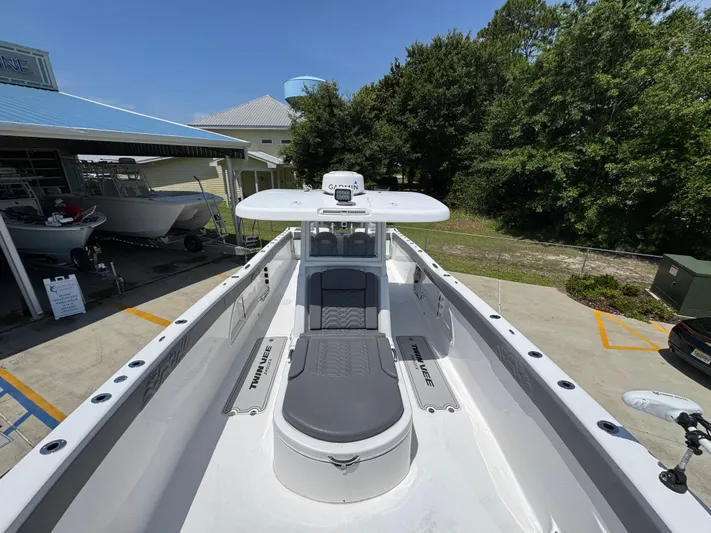  Yacht Photos Pics 2022 Twin Vee 340 GFX CC boat with sleek design, docked outdoors.