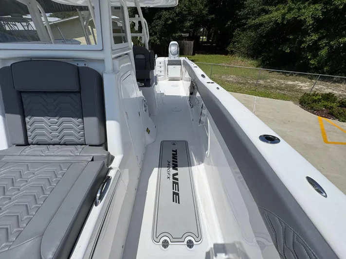  Yacht Photos Pics 2022 Twin Vee 340 GFX CC boat interior with sleek seating and spacious deck.