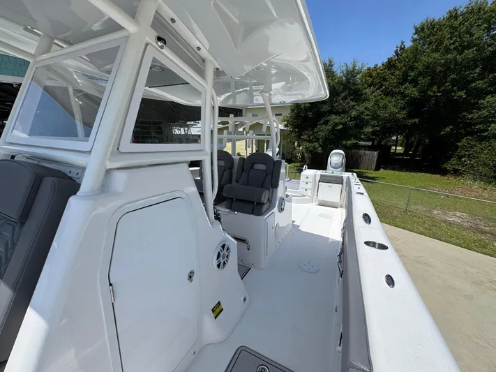  Yacht Photos Pics 2022 Twin Vee 340 GFX CC boat interior with seating and console, outdoors.