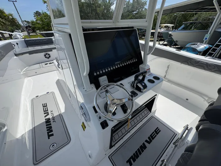  Yacht Photos Pics 2022 Twin Vee 340 GFX CC boat interior with steering console and seating area.