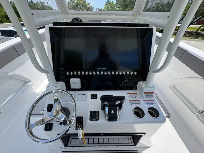  Yacht Photos Pics 2022 Twin Vee 340 GFX CC boat dashboard with steering wheel and controls.