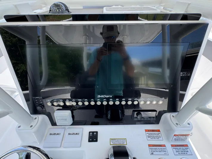  Yacht Photos Pics 2022 Twin Vee 340 GFX CC boat dashboard with controls and display screen.