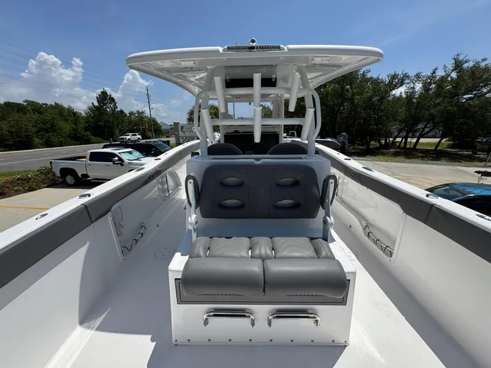  Yacht Photos Pics 2022 Twin Vee 340 GFX CC boat interior with seating and canopy under clear sky.