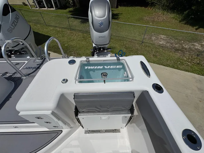  Yacht Photos Pics 2022 Twin Vee 340 GFX CC boat deck with Suzuki engine and storage compartments.