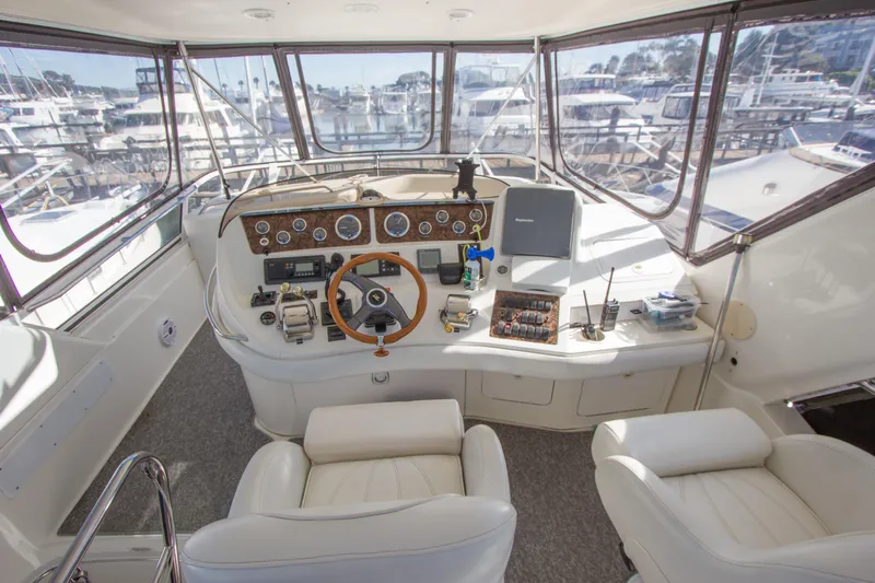 Eclipse Yacht Photos Pics 1998 Sea Ray 480 Sedan Bridge helm with leather seats and panoramic marina view.
