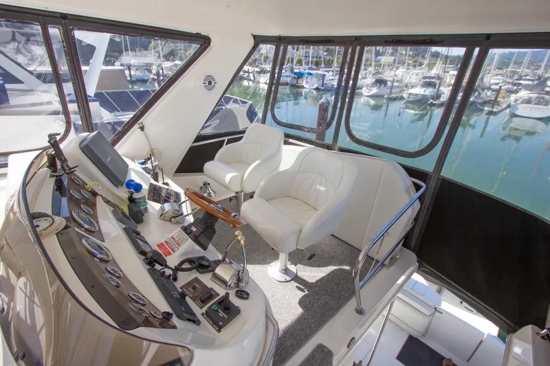 Eclipse Yacht Photos Pics Interior view of 1998 Sea Ray 480 Sedan Bridge yacht cockpit with marina backdrop.
