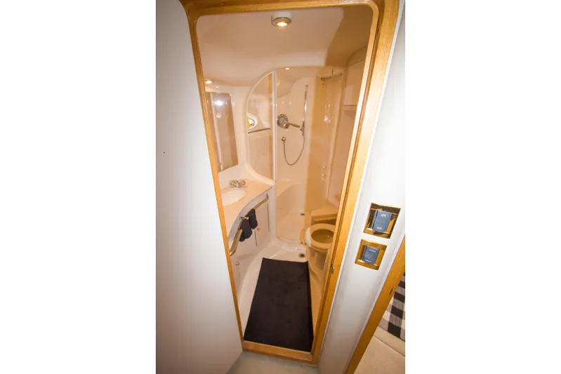 Eclipse Yacht Photos Pics Bathroom interior of 1998 Sea Ray 480 Sedan Bridge yacht, featuring shower and sink.