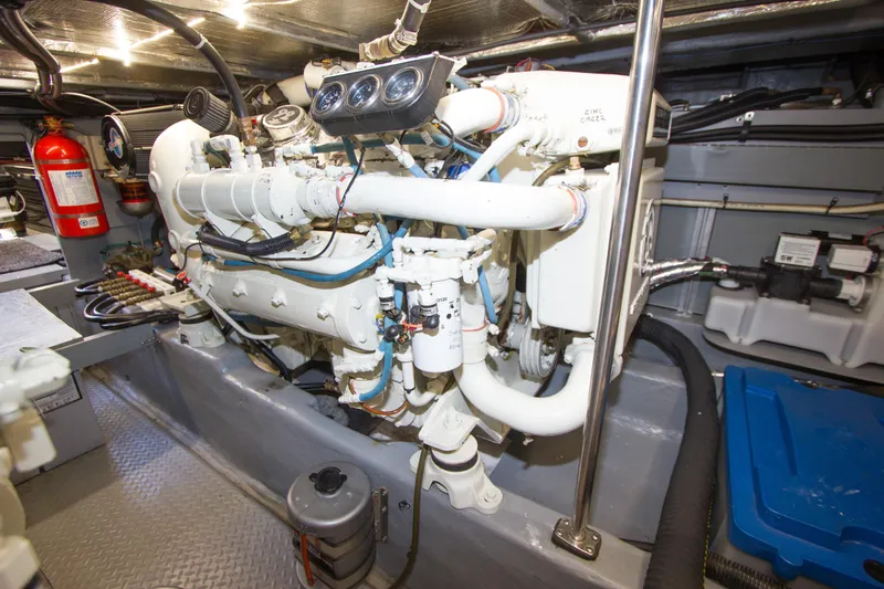 Eclipse Yacht Photos Pics Engine room of 1998 Sea Ray 480 Sedan Bridge with visible machinery and fire extinguisher.