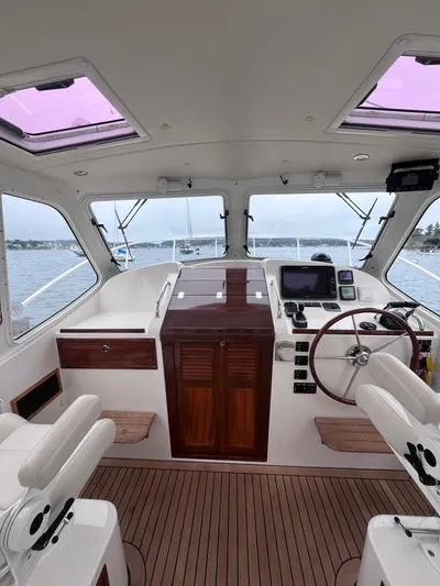 Barbican V Yacht Photos Pics Interior of 2014 MJM 36z Downeast boat with steering wheel and navigation equipment.