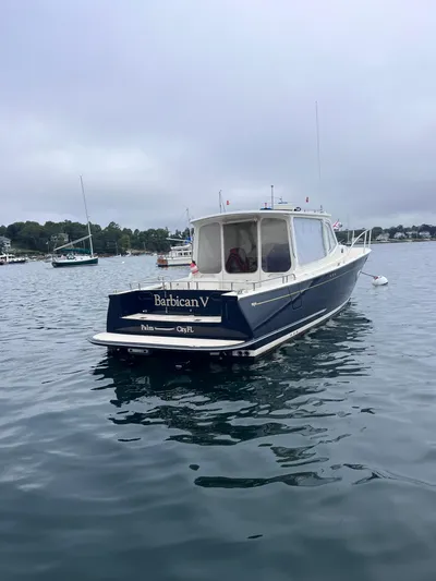 Barbican V Yacht Photos Pics 2014 MJM 36z Downeast boat on calm water, overcast sky.