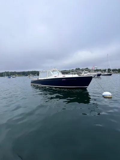 Barbican V Yacht Photos Pics 2014 MJM 36z Downeast boat on calm water, overcast sky.