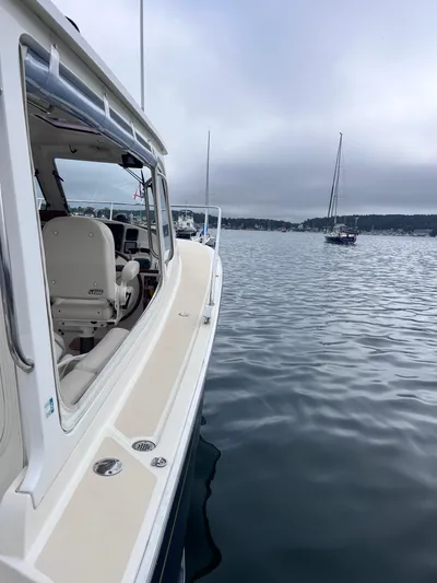 Barbican V Yacht Photos Pics 2014 MJM 36z Downeast boat on calm water with overcast sky.