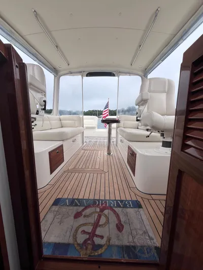 Barbican V Yacht Photos Pics Interior view of 2014 MJM 36z Downeast yacht with elegant seating and American flag.