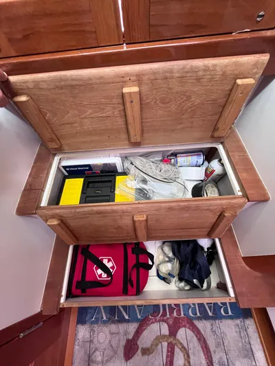 Barbican V Yacht Photos Pics Open storage compartment in 2014 MJM 36z Downeast boat with various items.