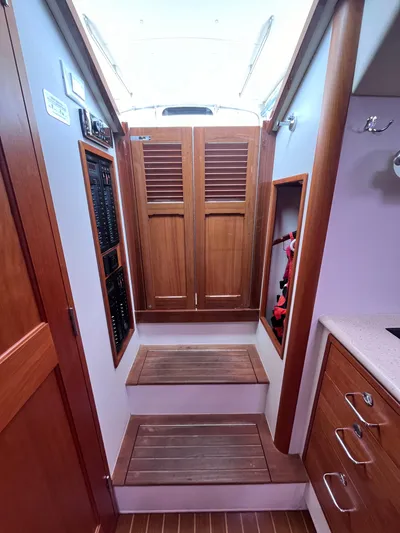 Barbican V Yacht Photos Pics 2014 MJM 36z Downeast yacht interior with wooden cabinetry and steps.