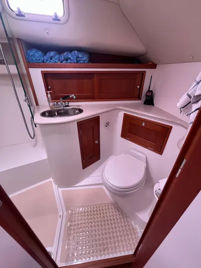 Barbican V Yacht Photos Pics 2014 MJM 36z Downeast yacht bathroom with sink, toilet, and storage cabinets.