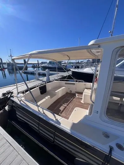 Barbican V Yacht Photos Pics 2014 MJM 36z Downeast boat docked at marina under clear blue sky.