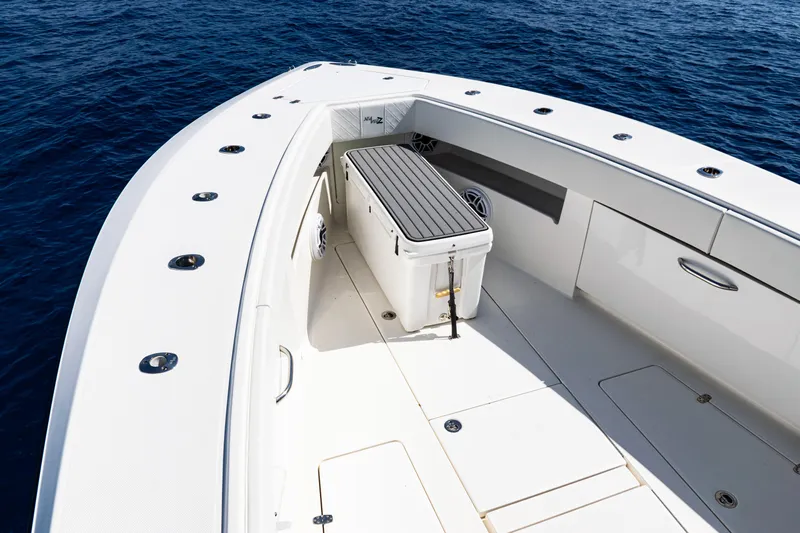  Yacht Photos Pics 2019 SeaVee 390Z boat deck with seating and storage, on calm blue ocean.
