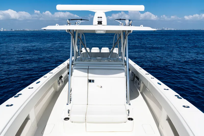  Yacht Photos Pics 2019 SeaVee 390Z boat on open ocean, clear sky, and distant city skyline.