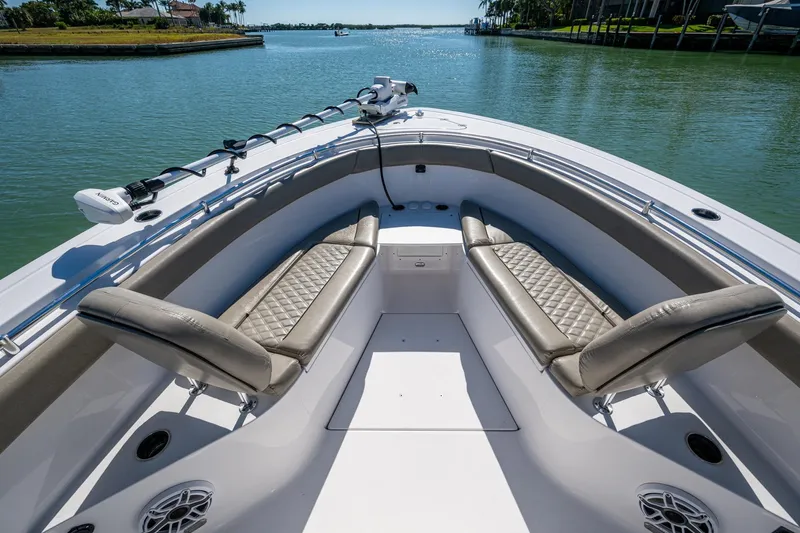  Yacht Photos Pics 2023 Sportsman Open 302 Center Console boat interior with luxurious seating on calm water.