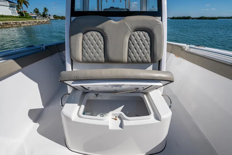  Yacht Photos Pics 2023 Sportsman Open 302 Center Console boat with cushioned seating and storage compartment.