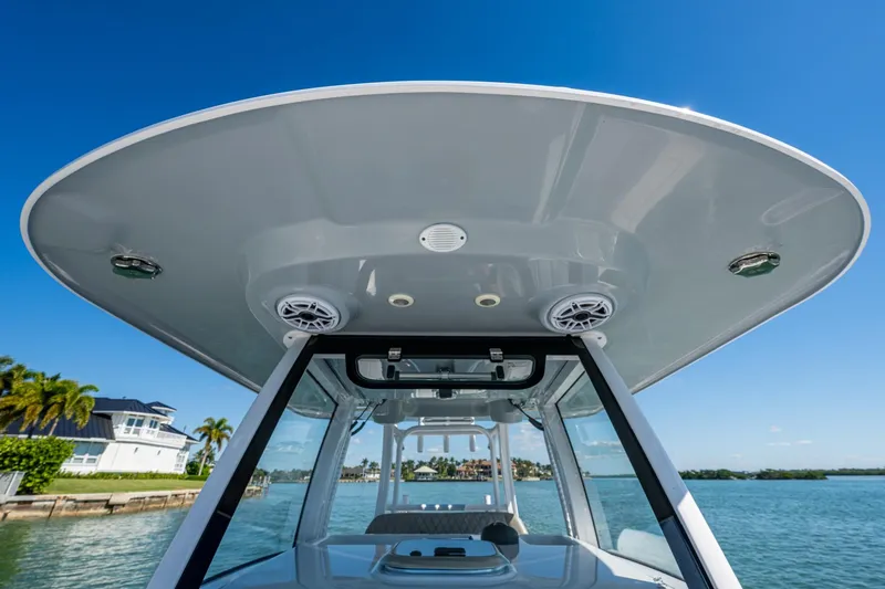  Yacht Photos Pics 2023 Sportsman Open 302 Center Console boat with sleek T-top design on a sunny day.